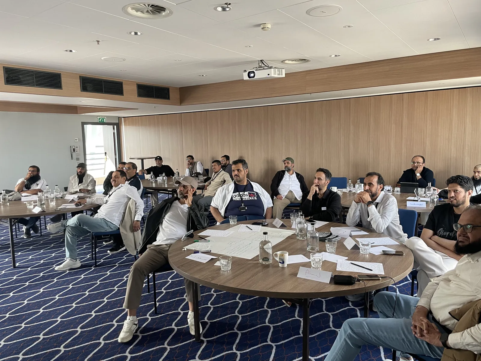 Delegates at round tables during an ARUK training course in a conference room