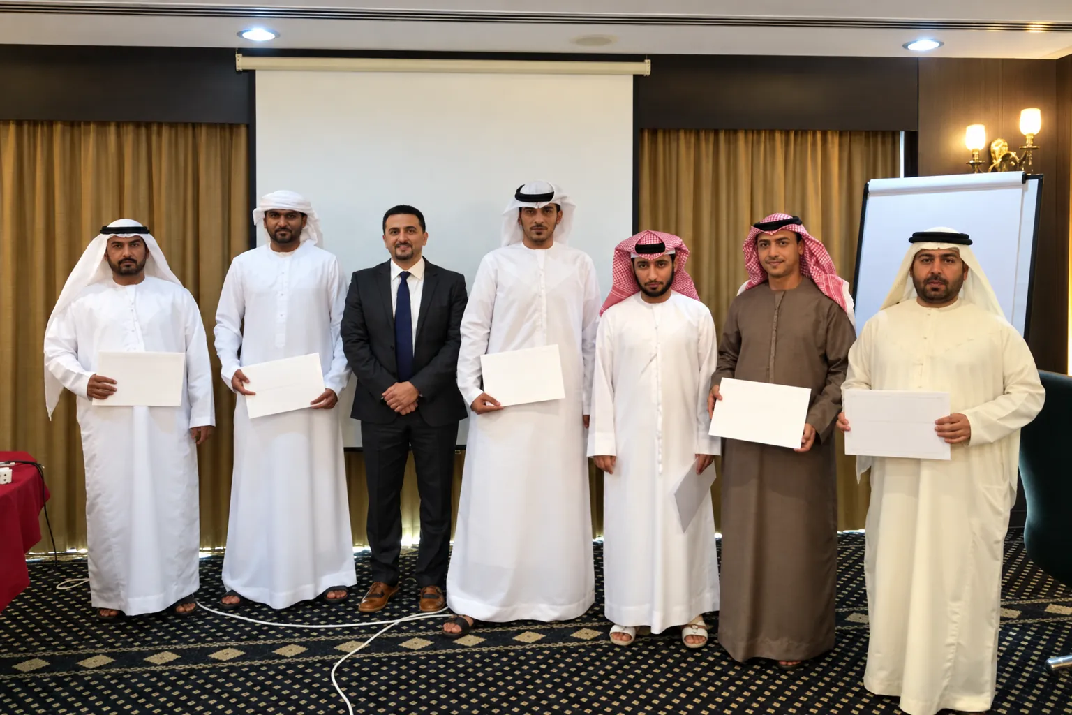 Gulf delegates with their trainer holding certificates after a course