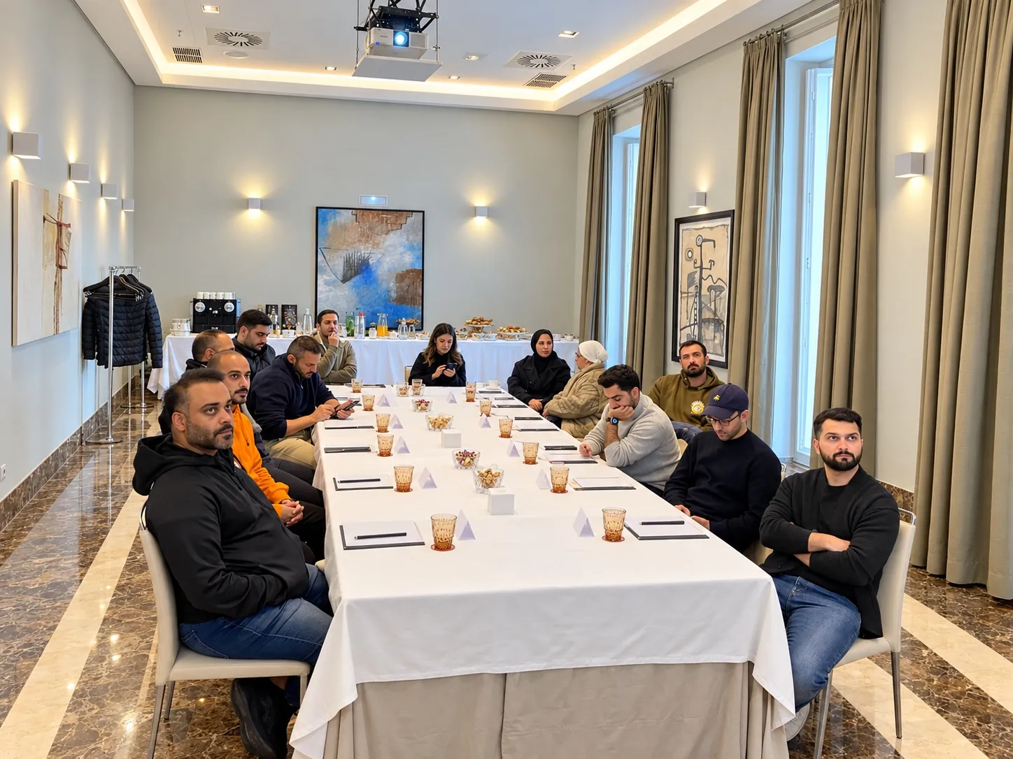 Long white-clothed table with delegates in a hotel meeting room